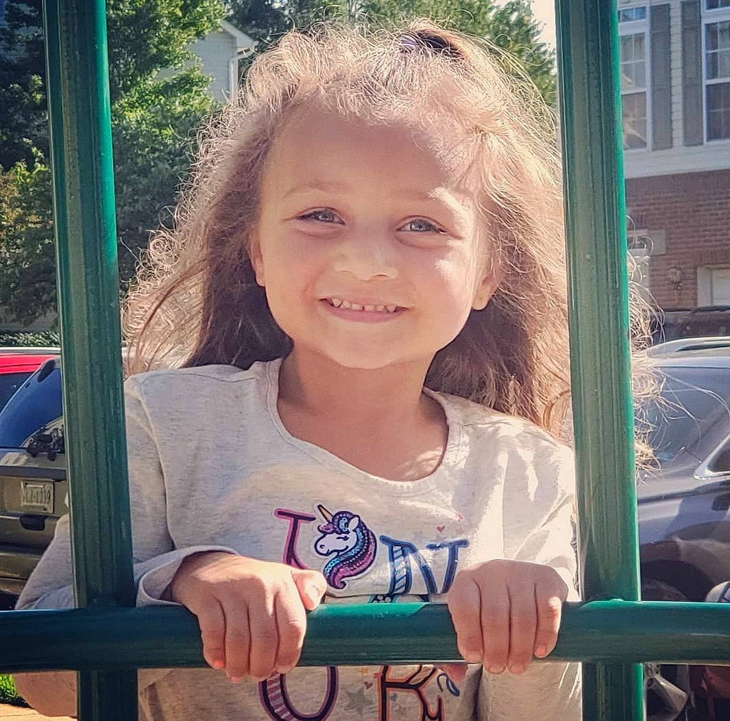 Jaycee is registered to the contest to win money with this photo: child, chin, cool, eye, facial_expression, finger, fun, grass, hairstyle, happy, iris, joy, person, photograph, public_space, skin, smile, standing, summer, toddler