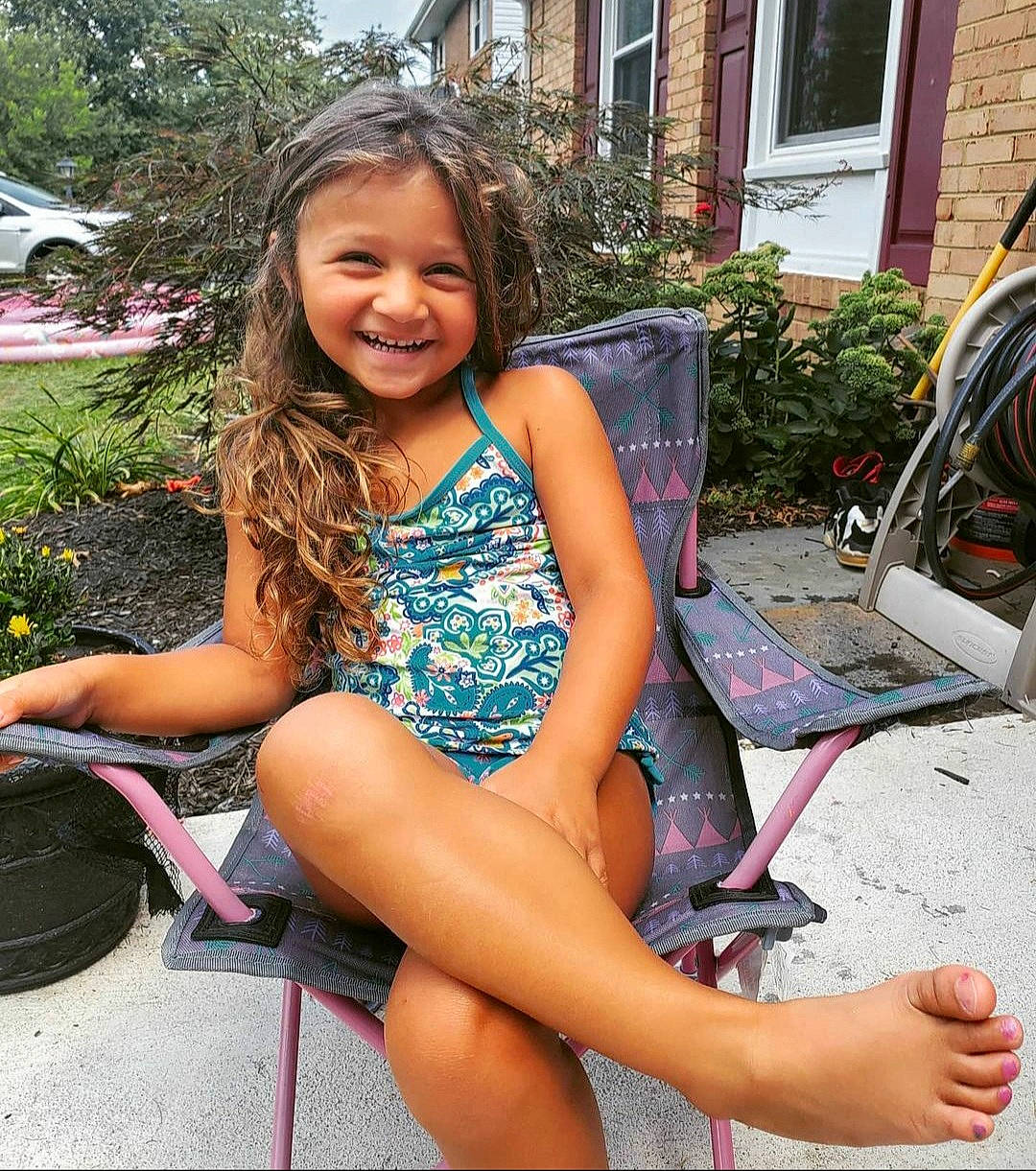 Jaycee is registered to the contest to win money with this photo: automotive_tire, facial_expression, fun, hair, hairstyle, happy, human_leg, jean_short, joy, knee, leg, leisure, person, pink, plant, shoe, smile, thigh, tire, tree