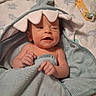 newborn, baby, infant, child, portrait, lying_down, blanket, hood, shark_hood, smiling, facial_expression, hands, bare_shoulders, bedding, pacifier_clip, nursery, indoor, cozy, close_up, photography