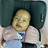 Jaliah joined the competition — help win amazing prizes! baby, infant, child, car_seat, safety_harness, portrait, face, eyes, smiling, seated, pink_clothing, hello_kitty, bib, mittens, cushion, vehicle_interior, travel, indoors, close_up, safe