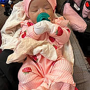 Jaliah is registered to the contest to win money with this photo: baby, sleeping, infant, pink_outfit, strawberry_pattern, hat, pacifier, mittens, blanket, car_seat, portrait, indoors, seated, peaceful, clothing, cuddly, face, head, baby_carrier, cozy