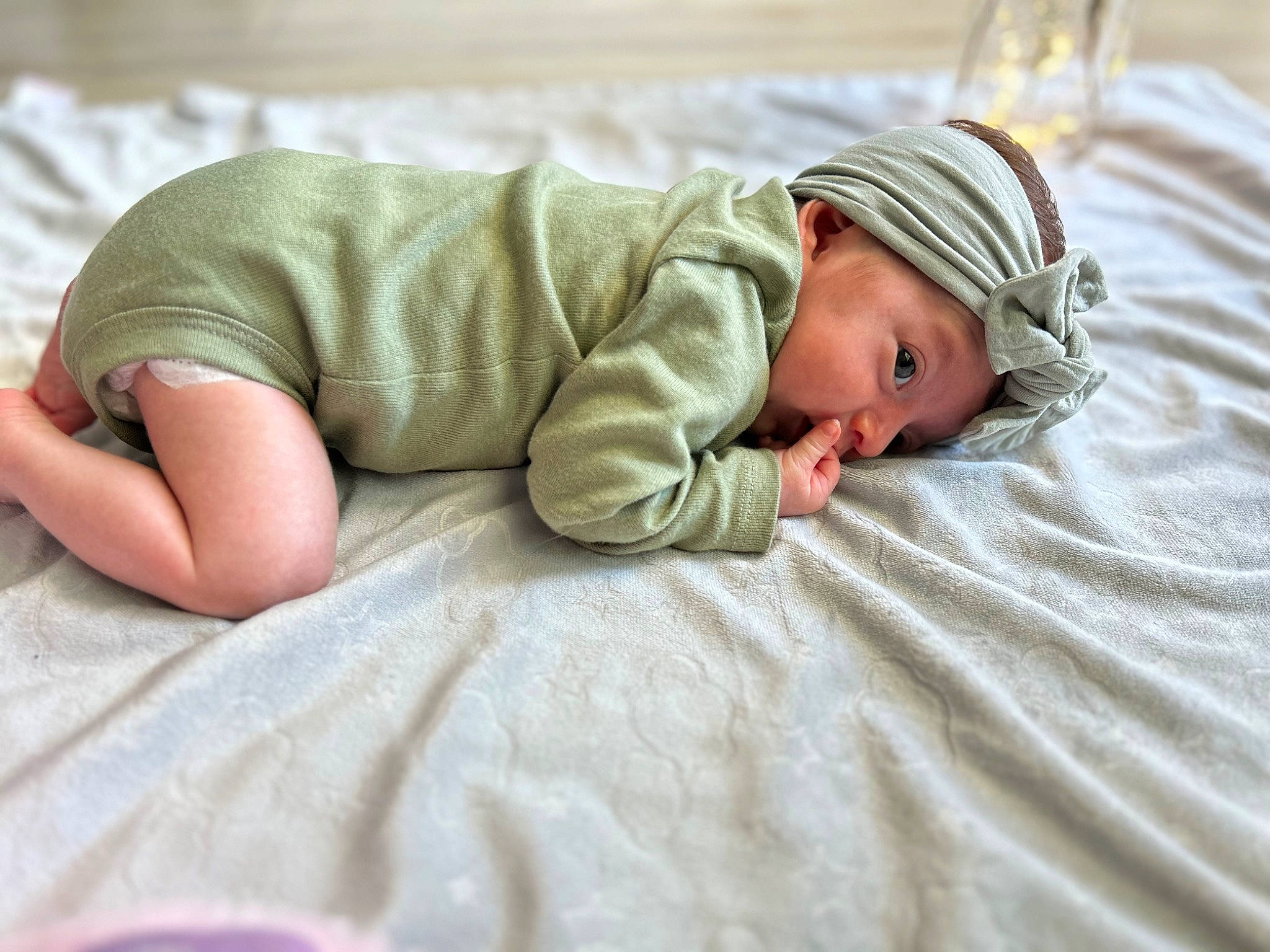 Arabella is registered to the contest to win money with this photo: art, baby, baby_sleeping, baby_toddler_clothing, bedding, bedtime, child, comfort, flooring, grass, headwear, linens, mammal, nap, person, portrait_photography, sitting, skin, sleep, sleeve