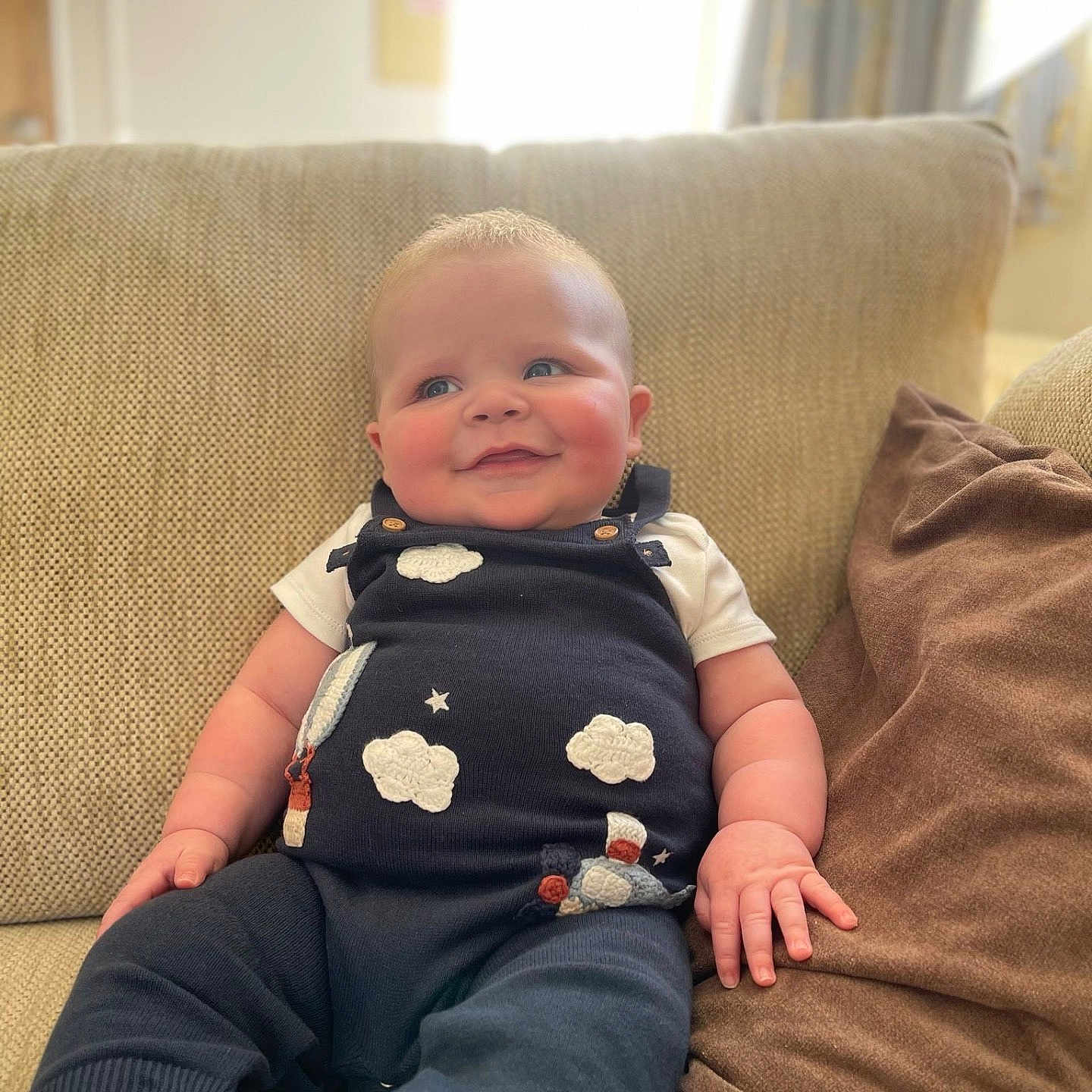 Barnaby is registered to the contest to win money with this photo: architecture, baby, building, clothing, couch, cushion, face, furniture, happy, head, homedecor, indoors, jeans, livingroom, pants, person, photography, portrait, room, sitting