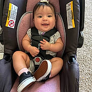 Aaliyah joined the competition — help win amazing prizes! baby, car_seat, smile, sneakers, infant, child, seatbelt, happy, indoor, toy, hair_bow, pink, black_shoes, car_seat_straps, carpet, clothing, person, cute, small_hands, infant_shoes