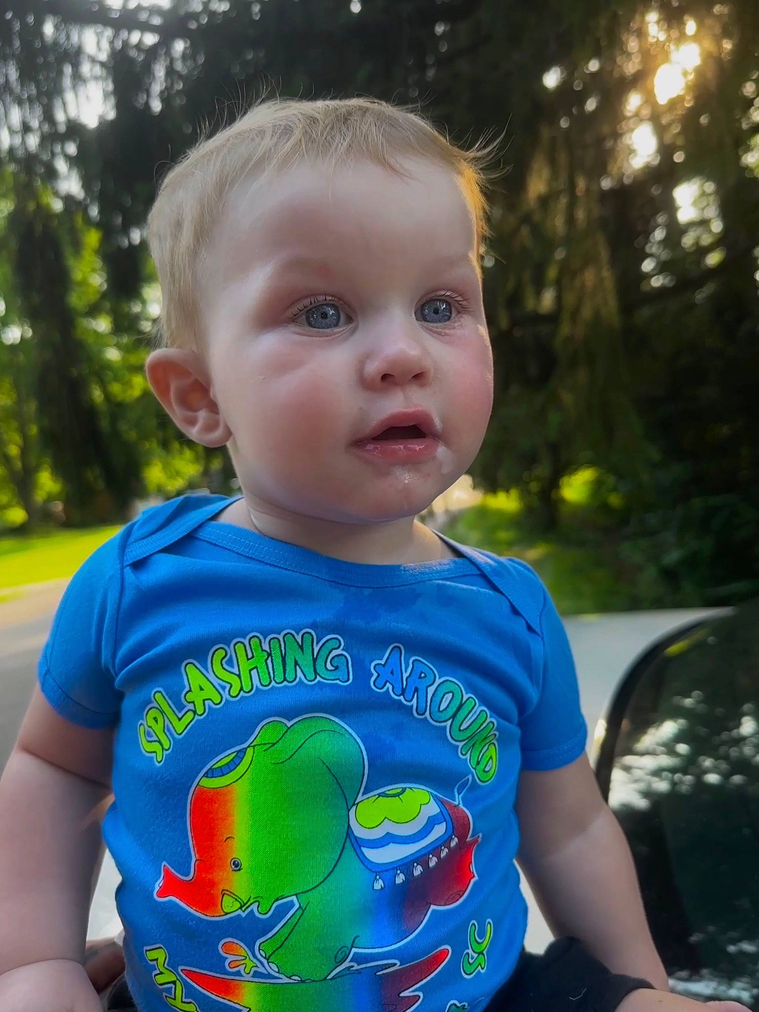 Jaylin is registered to the contest to win money with this photo: baby_toddler_clothing, cool, facial_expression, fun, grass, happy, iris, leaf, leisure, light, neck, people, people_in_nature, person, plant, sleeve, standing, sunlight, t_shirt, toddler