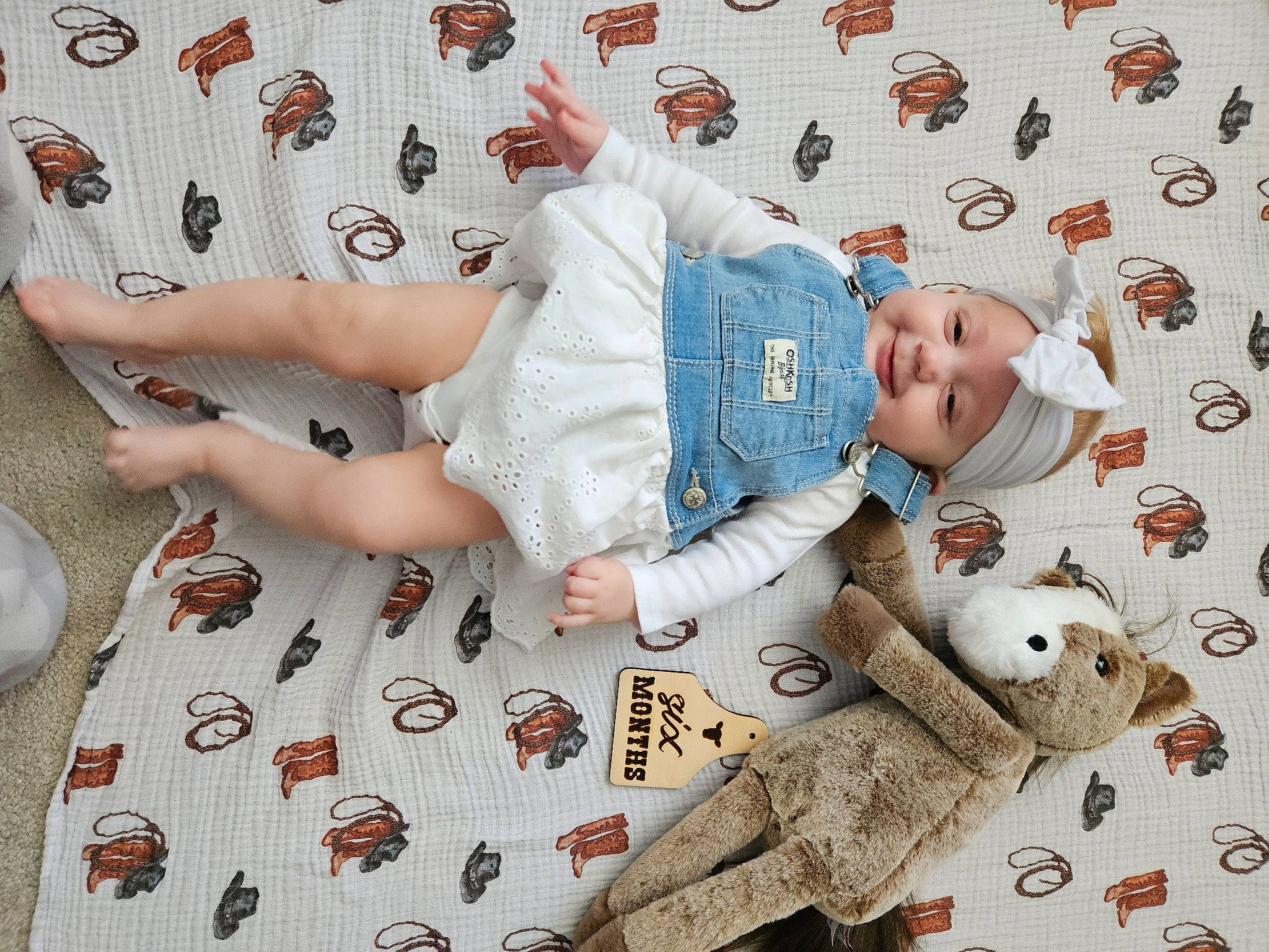 Kimber is registered to the contest to win money with this photo: baby, baby_sleeping, baby_toddler_clothing, bed_sheet, bedding, child, comfort, facial_expression, happy, headwear, human_leg, linens, pattern, person, room, sleeve, smile, stuffed_toy, t_shirt, textile