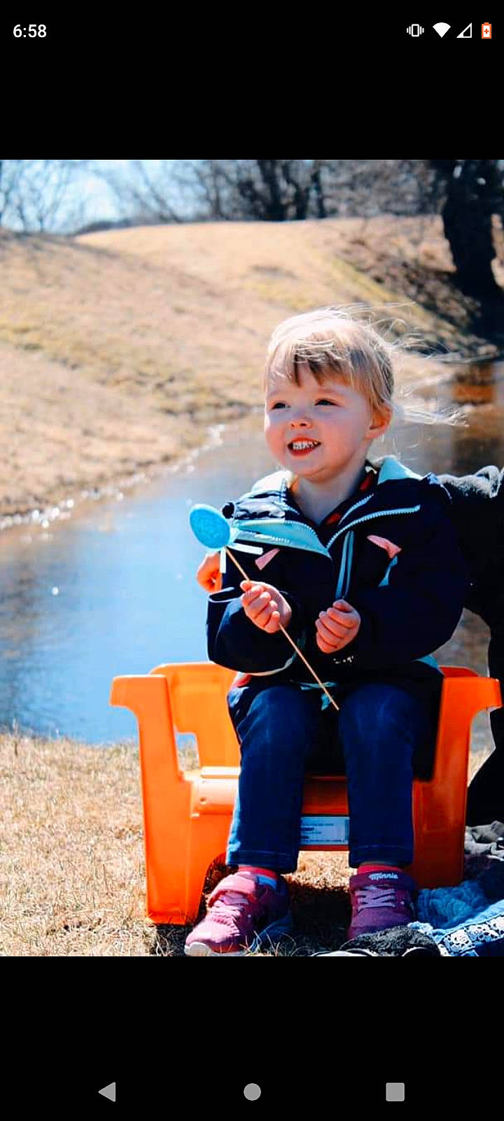 Nevaeh joined the competition — help win amazing prizes! boot, child, electric_blue, fun, grass, happy, joy, lake, landscape, leisure, people_in_nature, person, personal_protective_equipment, plant, play, recreation, sitting, toddler, travel, tree