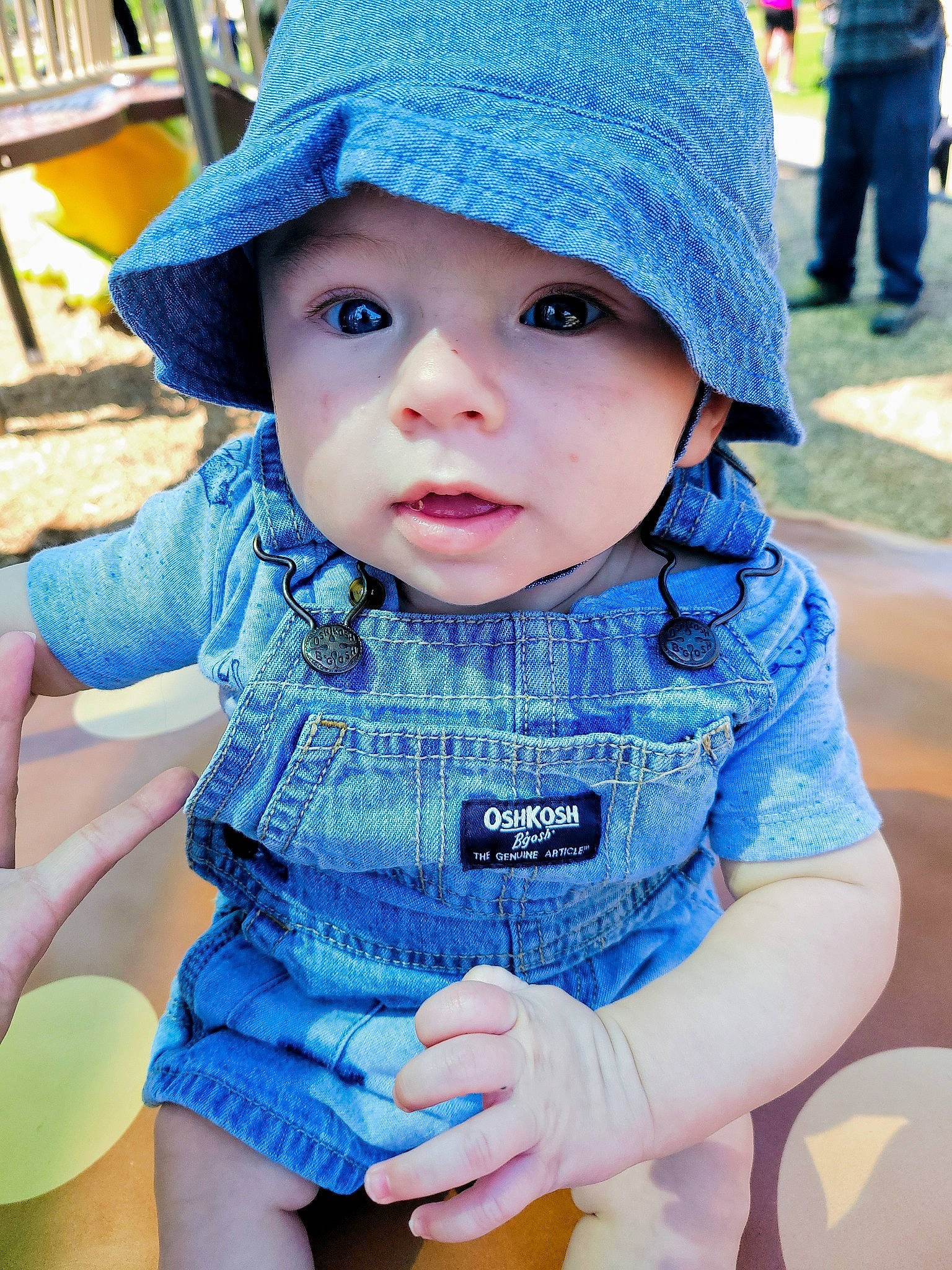 Lukka is registered to the contest to win money with this photo: baby, baby_toddler_clothing, blue, cap, child, cool, electric_blue, eye, face, facial_expression, fun, grass, happy, hat, headgear, headwear, leisure, pattern, person, photograph