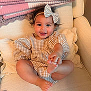 Alina joined the competition — help win amazing prizes! baby, smiling, child, bow, headband, checkered_pattern, dress, infant, happy, cute, sitting, barefoot, cozy, blanket, chair, indoor, portrait, person, furniture, soft_lighting