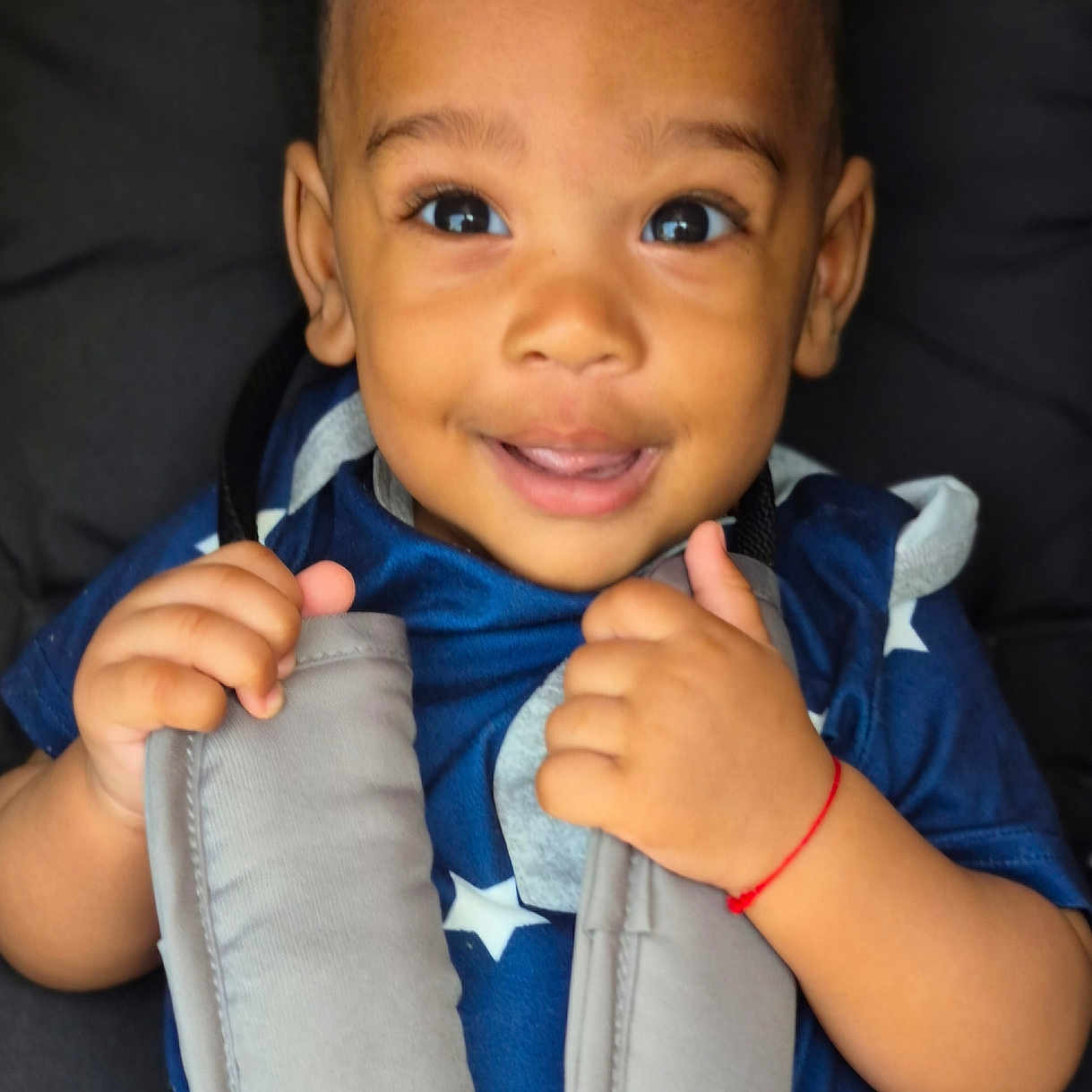 Jehlany a rejoint le concours — aidez-le/la à gagner de superbes lots ! baby, blue_clothing, car_seat, child, closeup, cute, face, hands, happy, harness, indoors, infant, person, portrait, seatbelt, sitting, smiling, stars_pattern, toddler, young_child