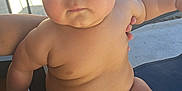 Leitan is registered to the contest to win money with this photo: baby, child, infant, skin, outdoor, fence, diaper, person, chubby, legs, arms, face, expression, holding, sunlight, shadow, blue, pattern, sitting, closeup