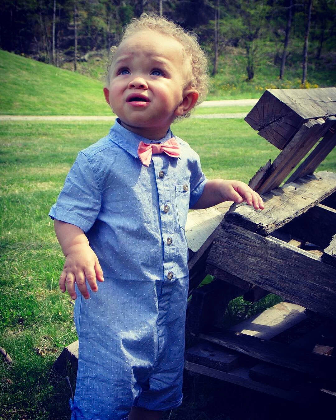 Laken is registered to the contest to win money with this photo: bow_tie, child, cool, denim, dress, formal_wear, fun, grass, happy, head, headwear, male, person, plant, smile, standing, suit, summer, suspenders, t_shirt