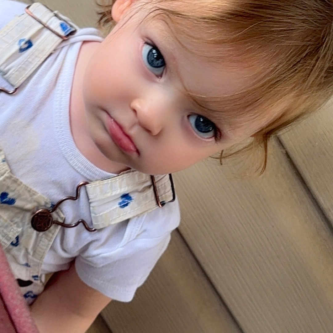 Willow is registered to the contest to win money with this photo: accessories, baby, blonde, blouse, clothing, costume, dress, earring, face, hair, head, jewelry, necklace, pants, person, photography, portrait, shorts, t_shirt, wood