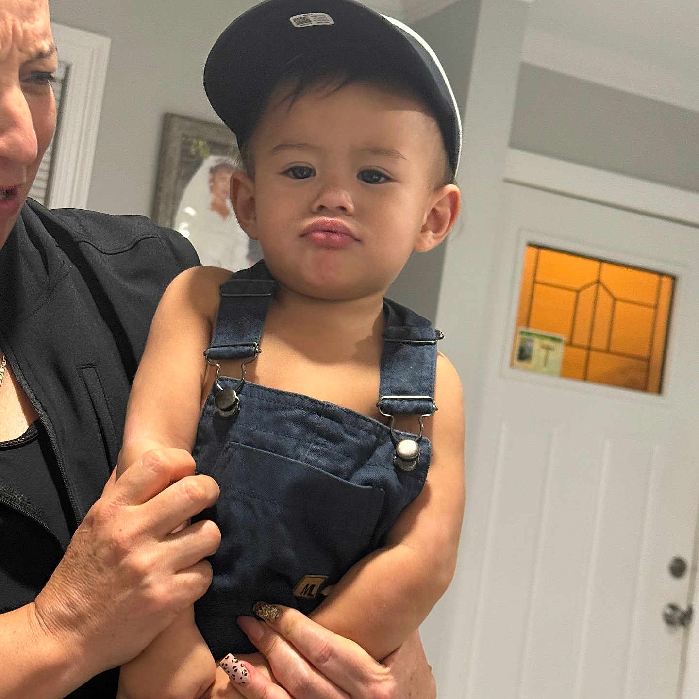 Luis Fernando Reyes joined the competition — help win amazing prizes! adult_hand, bracelet, cap, child, clothing, denim_overalls, door, expression, face, holding, indoor, nail_art, person, photograph_frame, portrait, pout, skin, toddler, wall, window