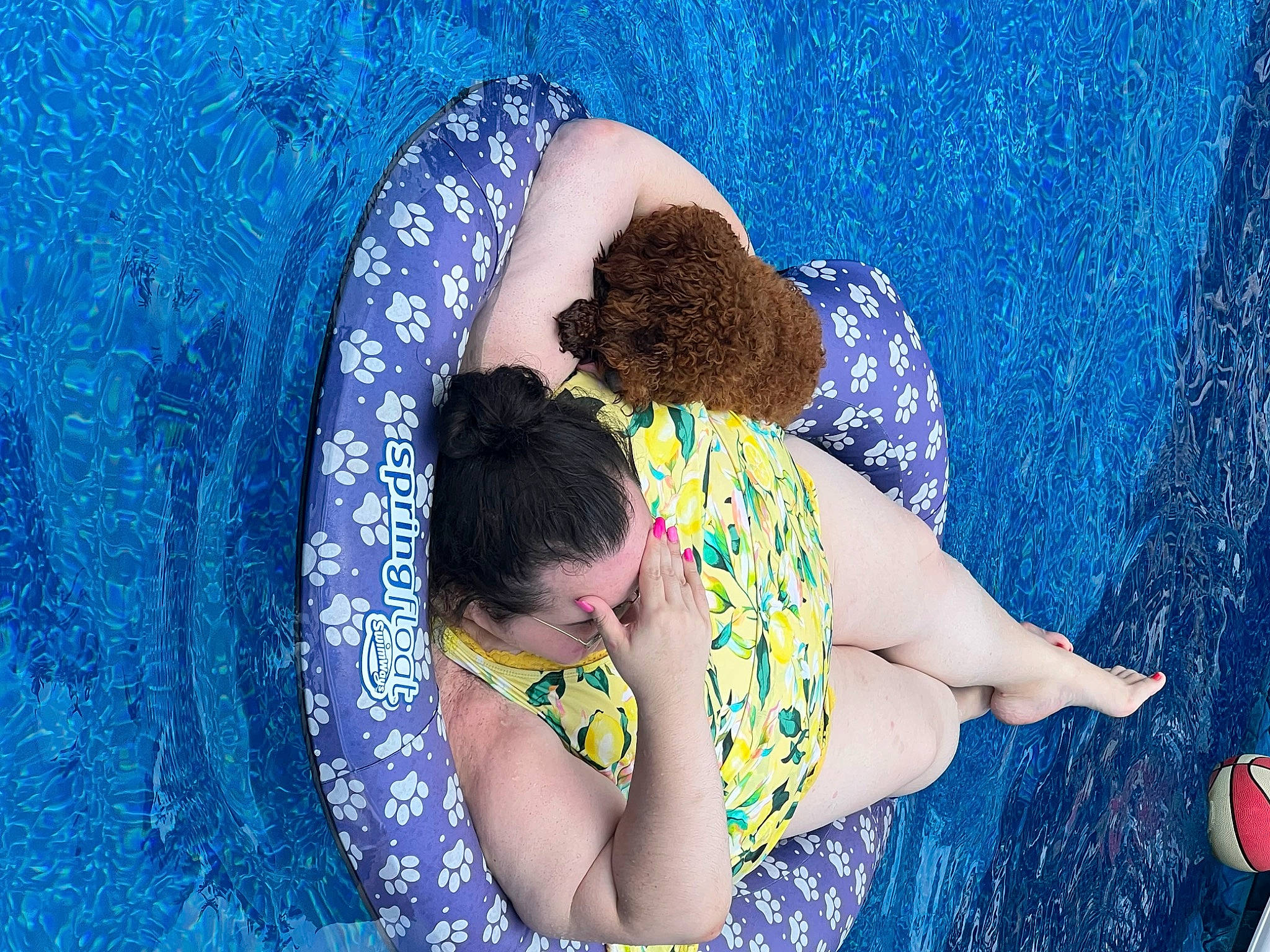 Tillie is registered to the contest to win money with this photo: aqua, azure, blue, circle, electric_blue, fun, games, grass, happy, leisure, pattern, people_in_nature, recreation, sitting, t_shirt, thigh, visual_arts, water, wave, wind_wave