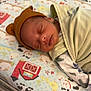 newborn, baby, sleeping, blanket, hat, bed, animal_print, barn, infant, cute, peaceful, child, indoors, soft, swaddle, nursery, rest, face, cozy, baby_bedding