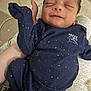 Kyrie is registered to the contest to win money with this photo: baby, newborn, infant, sleeping, person, clothing, blue_outfit, hand, arm, closeup, comfort, cute, peaceful, indoor, human, small, child, portrait, resting, soft