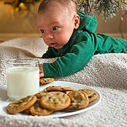 Pedro is registered to the contest to win money with this photo: baby, beverage, bread, breakfast, cookie, cracker, face, food, glass, head, lunch, meal, milk, person, photography, plant, portrait, pottedplant, snack, sweets