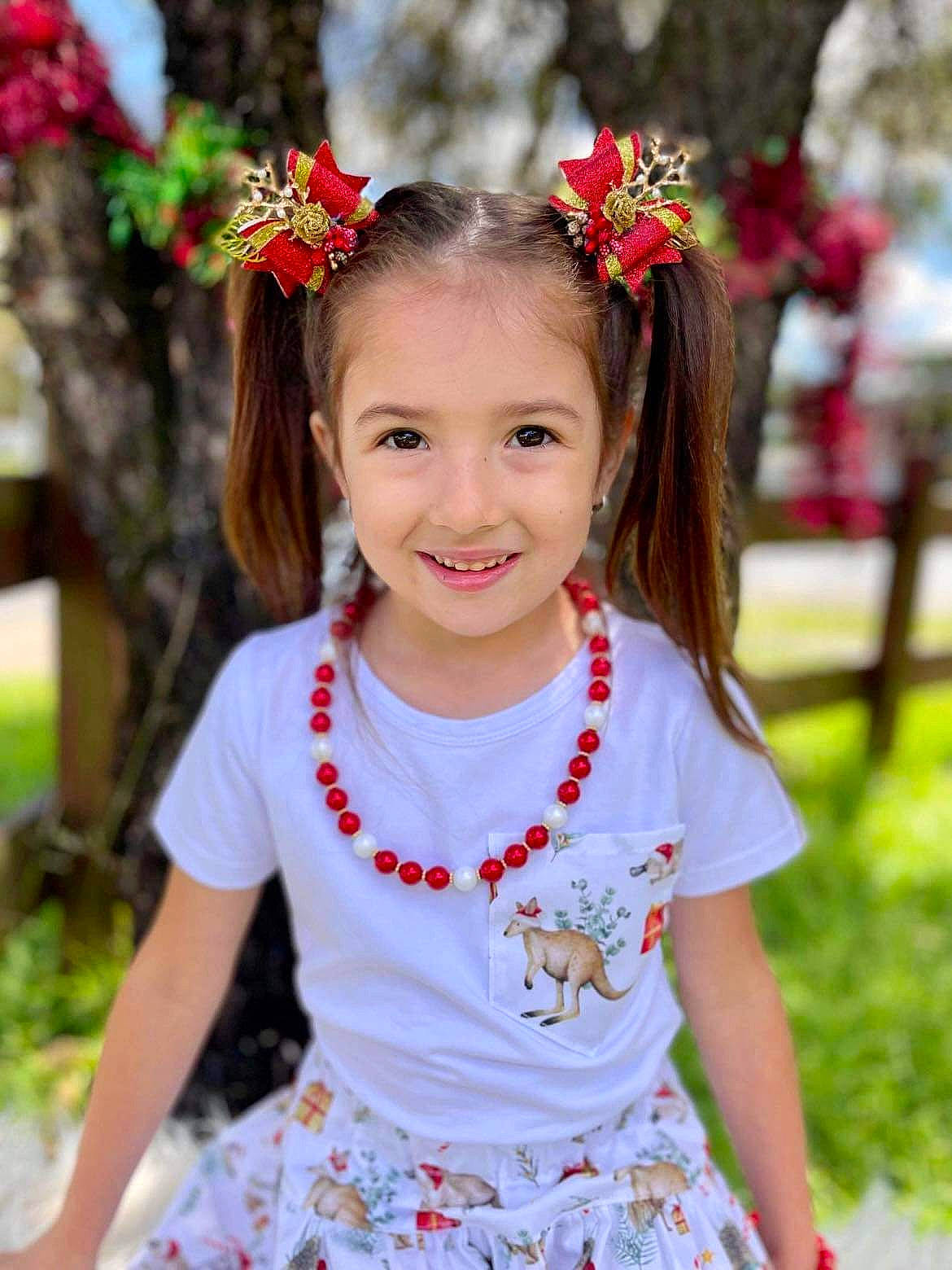 Ariel is registered to the contest to win money with this photo: baby_toddler_clothing, beauty, child, event, eye, flower, fun, grass, hair_accessory, hairstyle, happy, headpiece, jewellery, joy, person, pink, plant, red, sleeve, smile