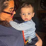 Jayann participe au concours pour gagner de l'argent avec cette photo : child, baby, infant, woman, adult, glasses, eyeglasses, holding, portrait, indoor, pacifier, pacifier_clip, striped_shirt, embrace, gaze, face, hair, cozy, bookshelf, clock