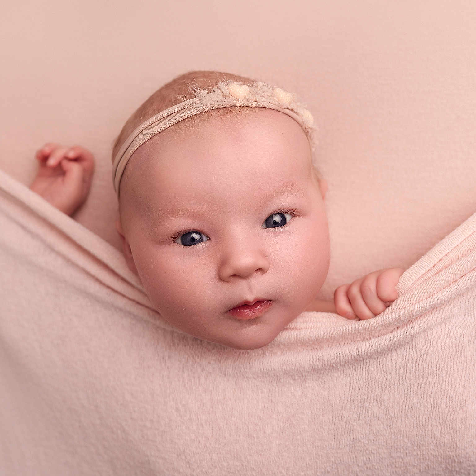 Elsie is registered to the contest to win money with this photo: adorable, baby, blanket, child, closeup, curious, cute, expression, face, hand, headband, indoor, infant, looking, newborn, pink, portrait, skin, soft_texture, young_child