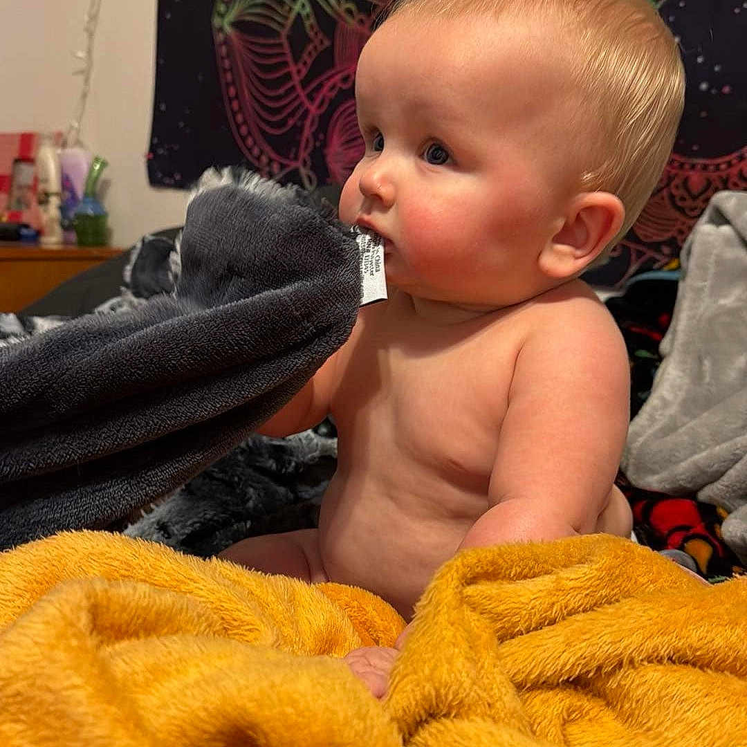 Declan is registered to the contest to win money with this photo: baby, blanket, brush, cutlery, device, eating, face, food, furniture, head, indoors, person, photography, plant, portrait, pottedplant, quilt, spoon, tool, towel