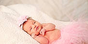 Kinsley is registered to the contest to win money with this photo: newborn, baby, infant, pink_tutu, headband, flower, blanket, soft_texture, cute, sleepy, portrait, lying_down, skin, small_hands, closeup, indoor, peaceful, adorable, child, tulle
