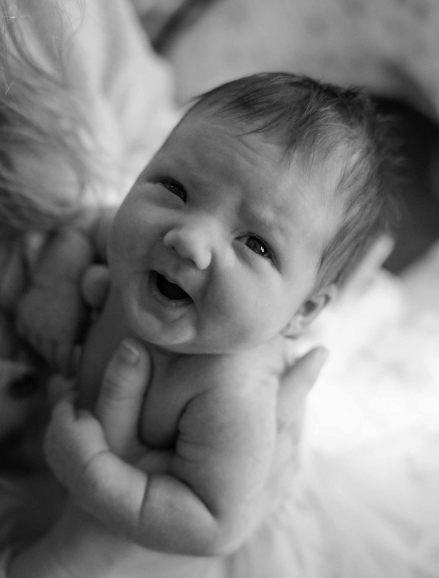 Kinsley is registered to the contest to win money with this photo: baby, infant, smile, face, skin, hand, person, portrait, newborn, cute, expression, child, black_and_white, closeup, soft_focus, happy, holding, parent, tenderness, love