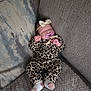 Kinsley is registered to the contest to win money with this photo: baby, sleeping, pacifier, headband, leopard_print, outfit, couch, pillow, blanket, infant, cozy, indoor, cute, child, resting, soft, patterned_clothing, sock, relaxed, portrait