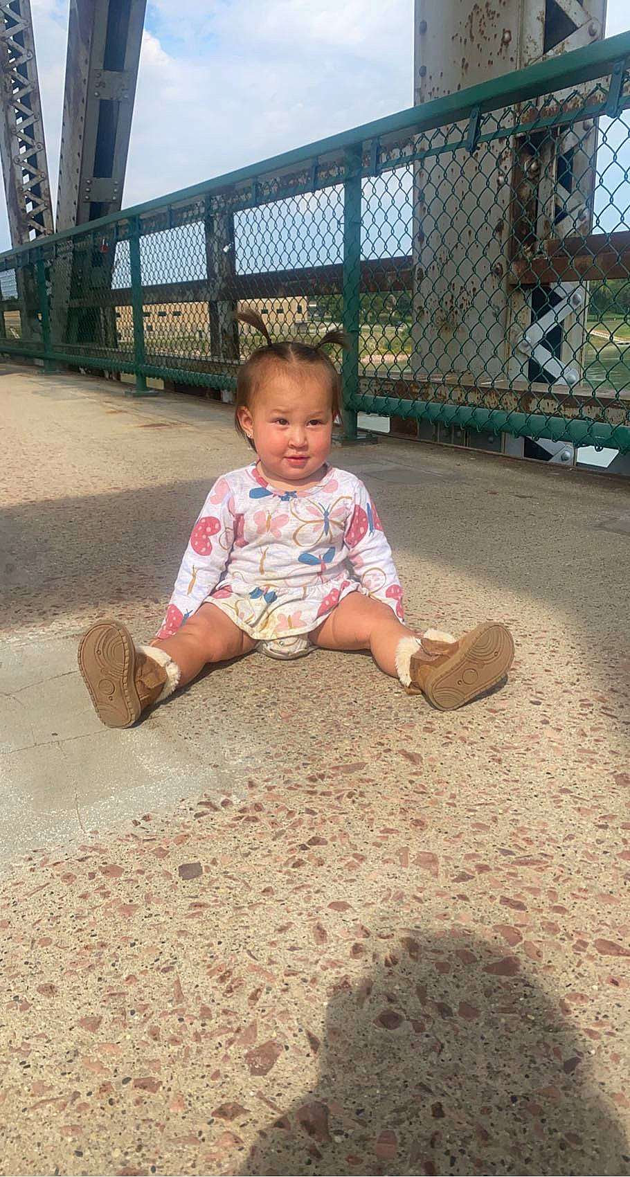 Winona joined the competition — help win amazing prizes! baby_toddler_clothing, child, city, fence, foot, fun, grass, human_leg, joy, leg, leisure, mammal, people, person, public_space, recreation, road_surface, sitting, sky, tints_and_shades