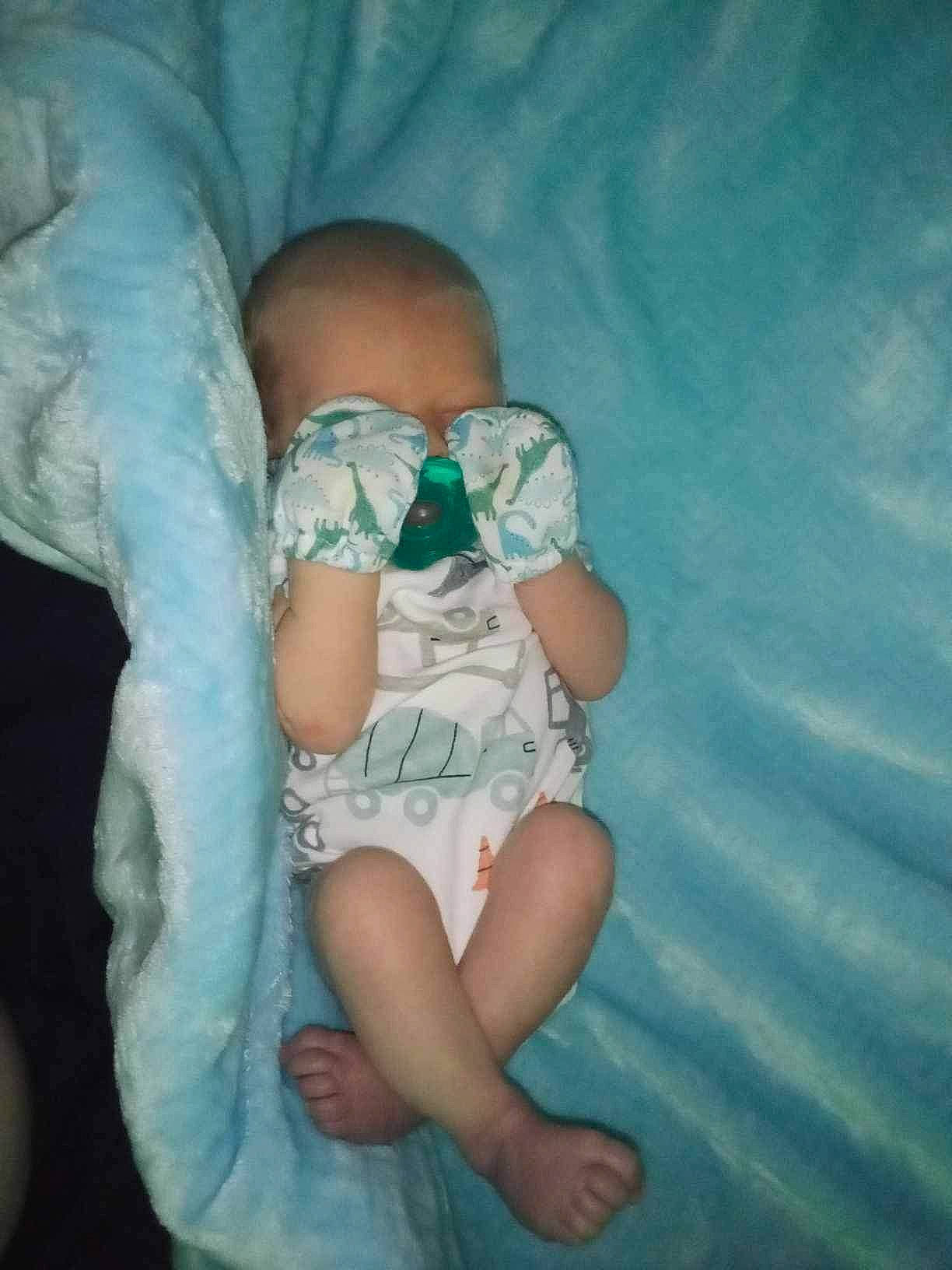 Everett is registered to the contest to win money with this photo: aqua, arm, baby, baby_toddler_clothing, comfort, elbow, eye, finger, gesture, glasses, hand, head, human_body, knee, leg, person, shoulder, sunglasses, thigh, trunk