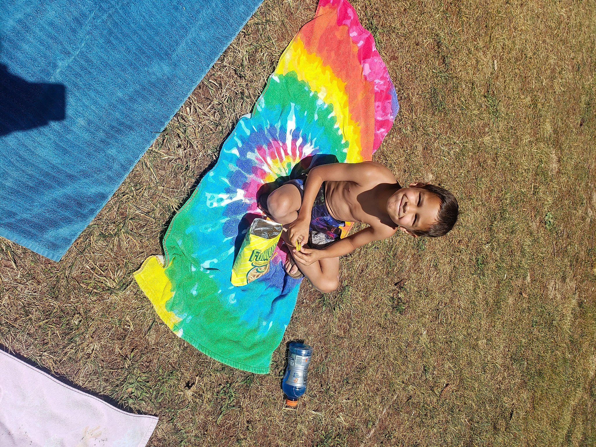 Julian is registered to the contest to win money with this photo: adventure, art, child, electric_blue, fun, grass, happy, joy, landscape, leisure, people_in_nature, person, play, recreation, rock, shadow, sitting, soil, t_shirt, toddler