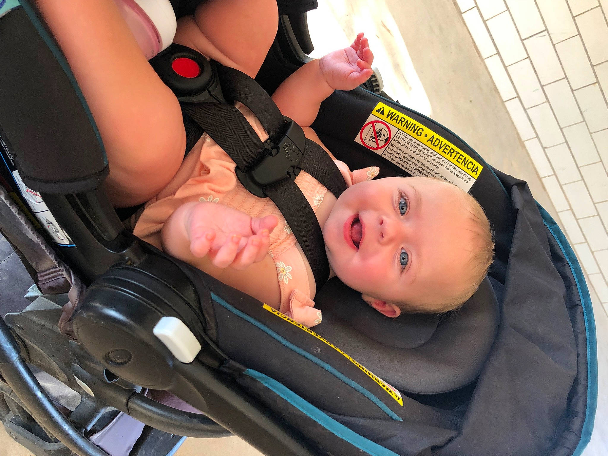 Emerie is registered to the contest to win money with this photo: arm, auto_part, baby, baby_carriage, baby_products, car_seat, child, comfort, fun, human_leg, joy, knee, lap, nail, person, personal_protective_equipment, service, sitting, thigh, tire