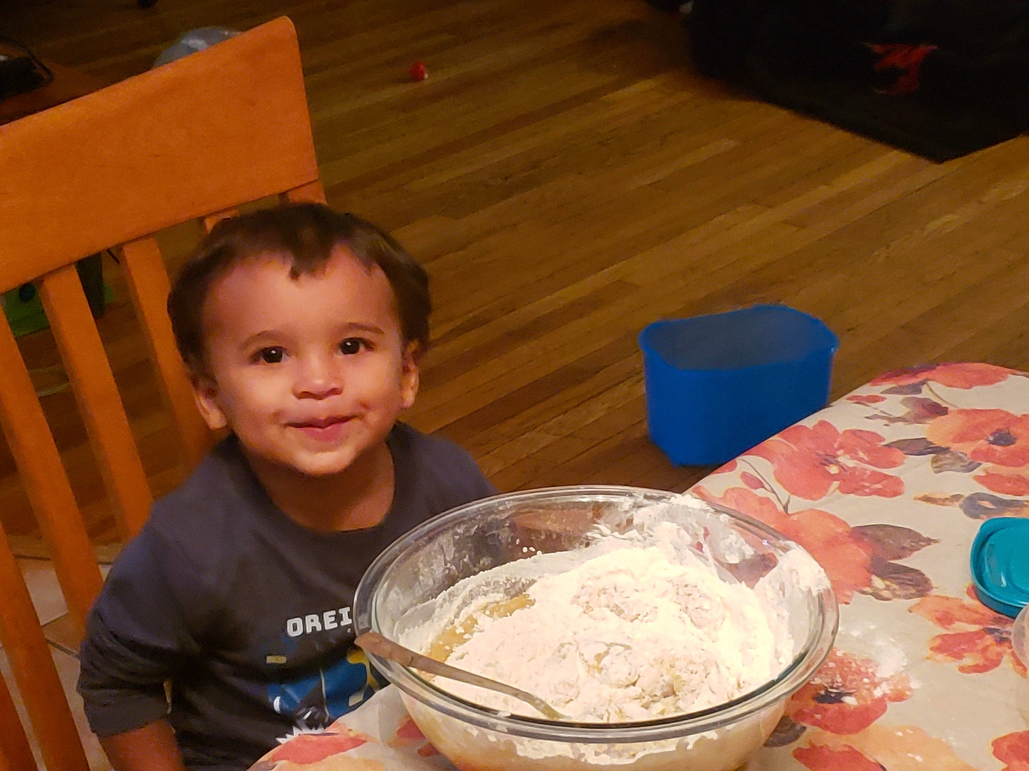 Enoch is registered to the contest to win money with this photo: all_purpose_flour, bowl, chair, child, comfort_food, cooking, cuisine, dish, dough, flooring, flour, food, hardwood, ingredient, joy, person, powder, recipe, smile, toddler