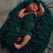 Ella joined the competition — help win amazing prizes! baby, sleeping, blanket, headband, cushion, teal, infant, newborn, soft_texture, wrapped, peaceful, resting, cozy, cute, skin, feet, hand, portrait, indoors, fabric