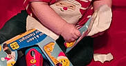 Braxton joined the competition — help win amazing prizes! baby, box, bright_light, candid, child, exploring, festive, flashlight, hands, holiday, indoor, infant, person, playing, red_background, red_shirt, santa_claus, striped_clothing, torn_box, toy