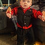 Skyler joined the competition — help win amazing prizes! child, toddler, person, adult, clothing, suit, vest, shirt, carpet, couch, hand, toy, indoor, living_room, footwear, expression, support, curious, home, family