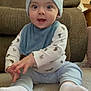 Skyler joined the competition — help win amazing prizes! baby, child, infant, sitting, carpet, couch, beanie, blue_clothing, socks, long_sleeve_shirt, animal_print, home_interior, furniture, smiling, cute, young_child, person, indoors, happy, playful