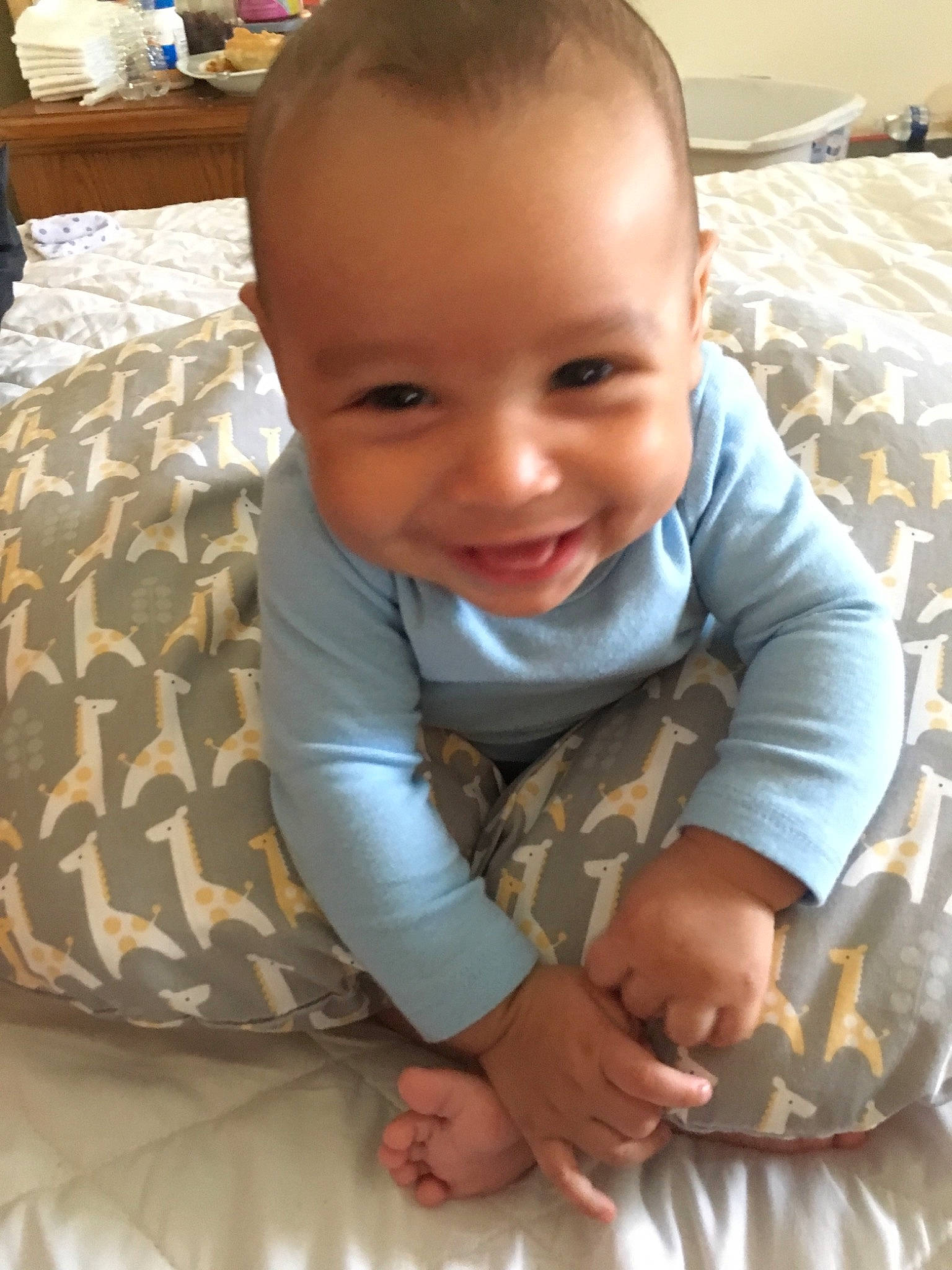Brenden is registered to the contest to win money with this photo: baby, baby_toddler_clothing, cheek, child, crawling, face, facial_expression, head, mouth, nose, person, play, product, sitting, skin, smile, toddler, tummy_time