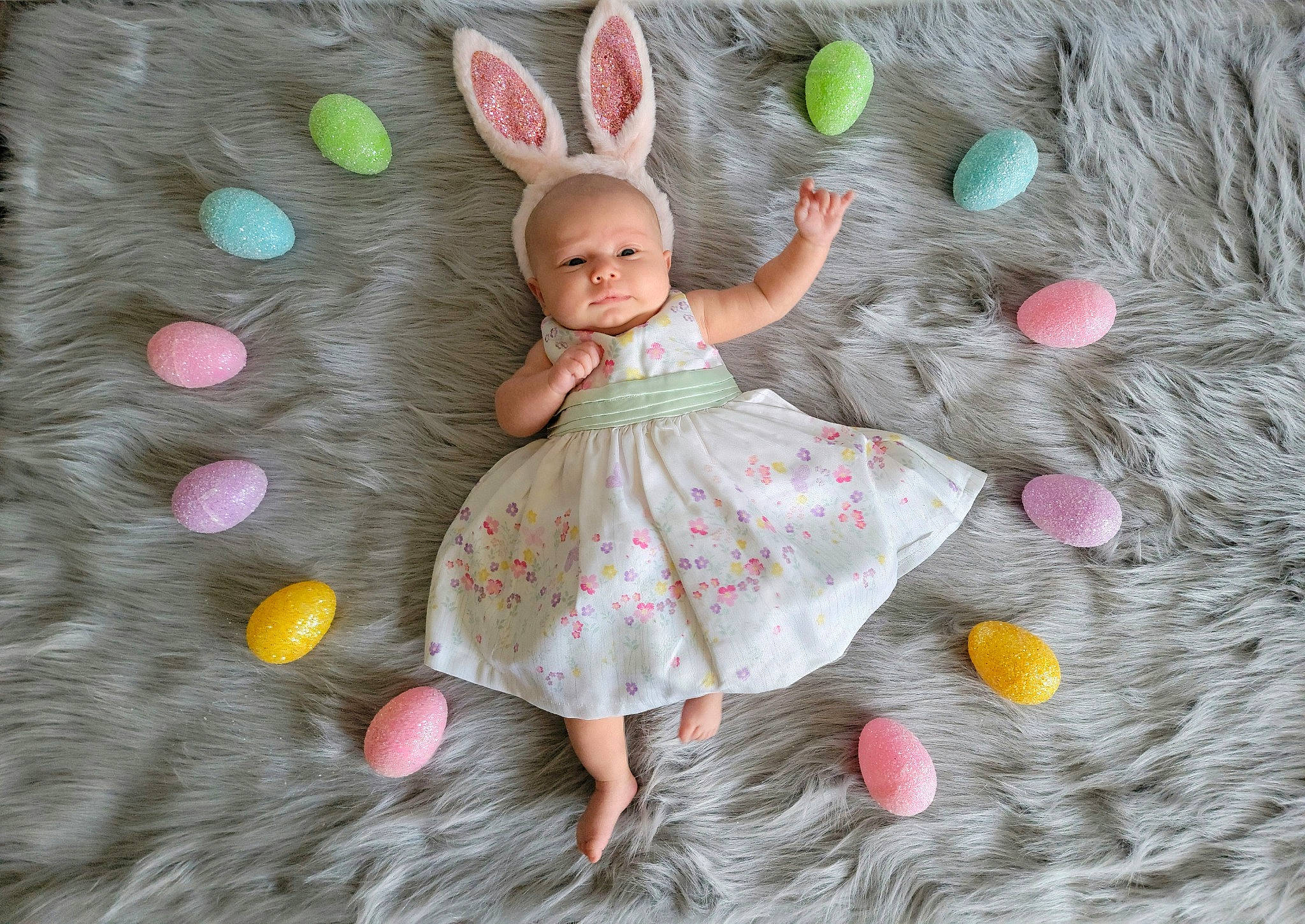 Ellie is registered to the contest to win money with this photo: arm, baby, baby_toddler_clothing, butterfly, dress, fawn, fictional_character, grass, happy, illustration, linens, magenta, mythical_creature, pattern, people_in_nature, person, pink, sleeve, textile, toddler