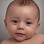 baby, infant, portrait, close_up, face, eyes, cheeks, skin, hair, eyelashes, bare_shoulders, looking_at_camera, cute, studio, neutral_background, expression, head, young_child, smiling_subtle, human