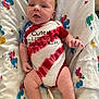 baby, blanket, blue, chubby, clothing, cute, duck_pattern, expression, fabric, foot, hand, infant, lying_down, onesie, pacifier, person, red, skin, tie_dye, white
