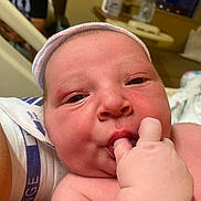 Gary joined the competition — help win amazing prizes! newborn, baby, infant, hospital, close_up, face, hand, fingers, cap, skin, sleepy, person, medical, bed, blanket, hospital_wristband, indoors, cute, child, newborn_baby
