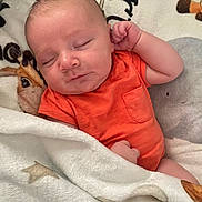Gary joined the competition — help win amazing prizes! baby, newborn, sleeping, orange_onesie, blanket, animal_pattern, cozy, infant, cute, peaceful, soft_texture, closeup, portrait, resting, child, human, skin, head, hand, indoors