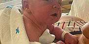Gary joined the competition — help win amazing prizes! baby, newborn, blanket, hospital, infant, person, skin, face, head, arm, bed, window, light, striped_clothing, hospital_bed, medical_equipment, wristband, cuddle, resting, indoor