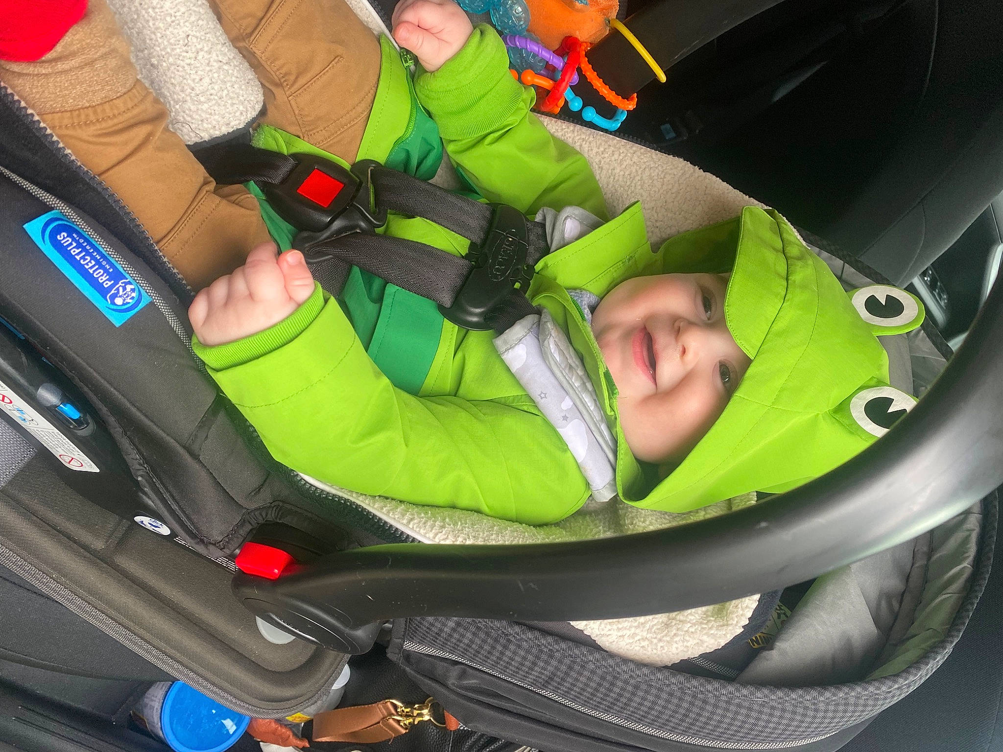 Crew is registered to the contest to win money with this photo: auto_part, automotive_design, automotive_exterior, baby_carriage, bag, car_seat, comfort, grass, green, headwear, lap, leisure, mode_of_transport, motor_vehicle, person, personal_protective_equipment, plant, recreation, tire, vehicle