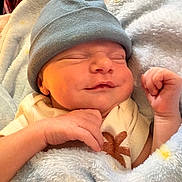Julius is registered to the contest to win money with this photo: newborn, baby, sleeping, hat, blanket, smile, infant, cozy, cute, soft, warm, wrapped, child, face, hand, resting, indoors, portrait, peaceful, adorable