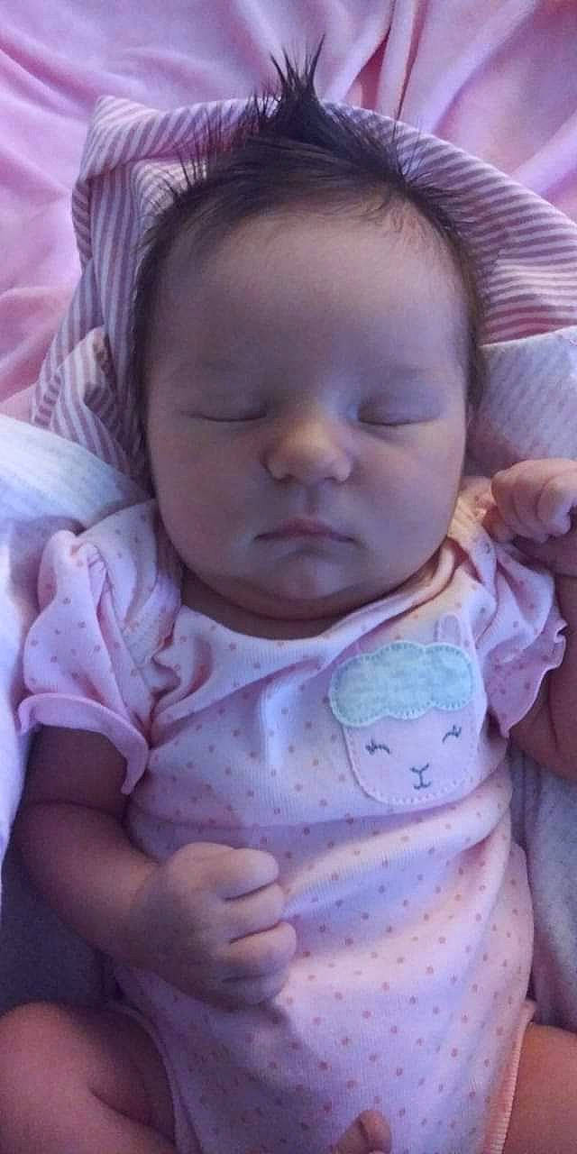 Chevy is registered to the contest to win money with this photo: baby, baby_toddler_clothing, cheek, chin, comfort, eye, eyebrow, finger, happy, head, iris, lip, mouth, neck, nose, person, pink, skin, sleeve, textile