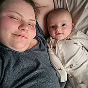 Lucas joined the competition — help win amazing prizes! adult, baby, bed, blanket, clothing, cute, face, family, happy, head, lying_down, onesie, person, portrait, resting, smile, together, two_people, warm, young_child