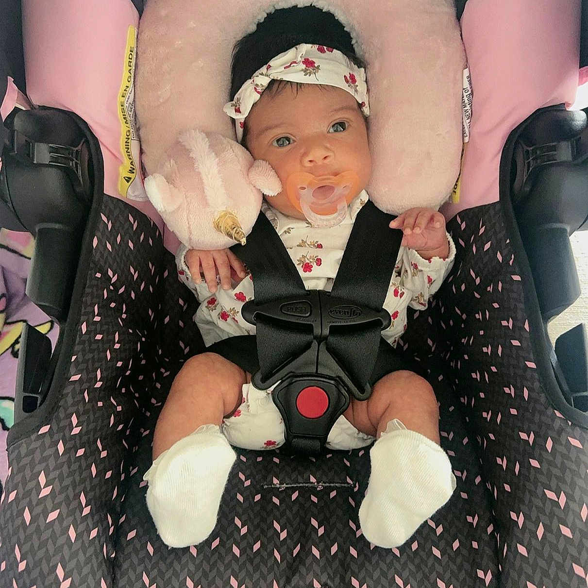Amy Salome joined the competition — help win amazing prizes! baby, infant, child, car_seat, harness, pacifier, headband, floral_clothing, pink, plush_toy, sitting, portrait, wide_eyes, indoors, vehicle, safety, blanket, cushion, baby_clothing, photography